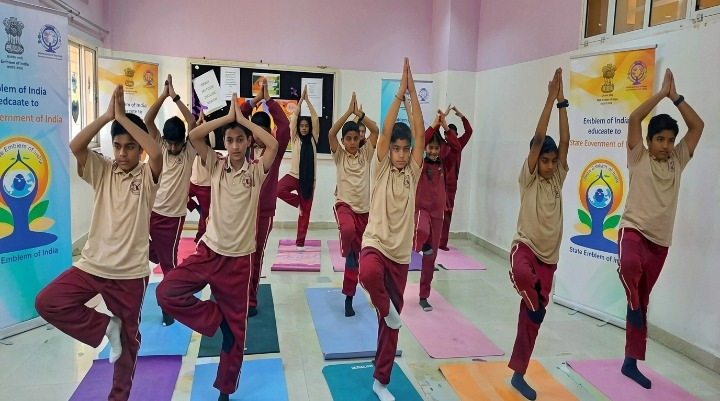 Students practicing tree pose during yoga session
