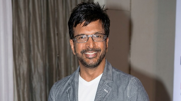 Jaaved Jaaferi Smiling wearing glasses