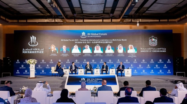 Panel discussion on stage at the IM Global Forum with an audience watching from the foreground