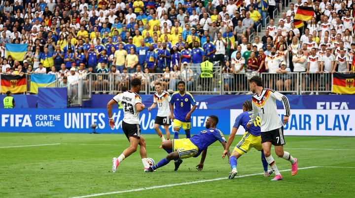 Players competing on soccer field