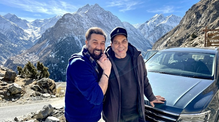 Dharmendra and Sunny Deol smiling in mountains